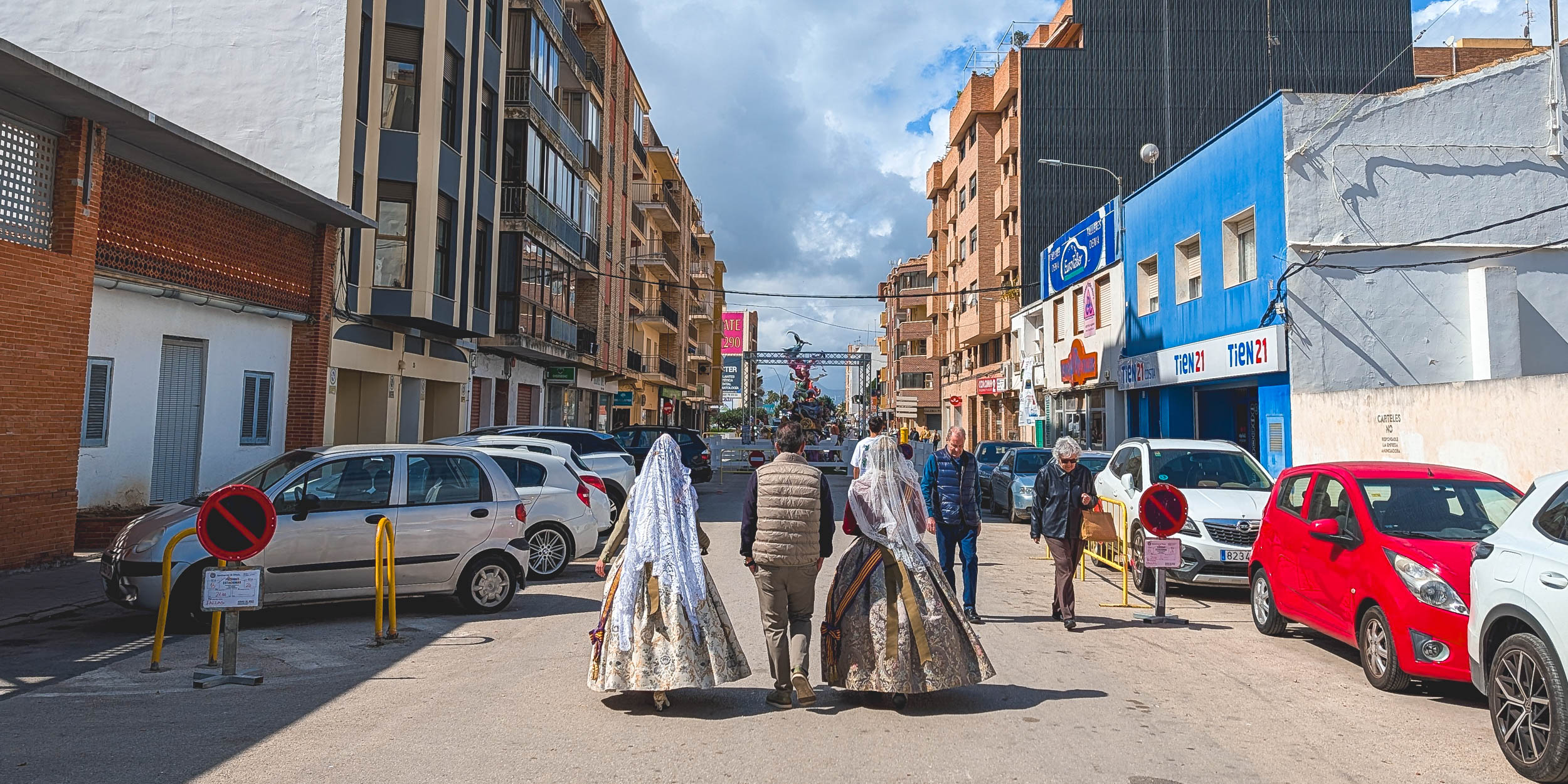Two falleras walking towards Falla Campaments, Denia 2026