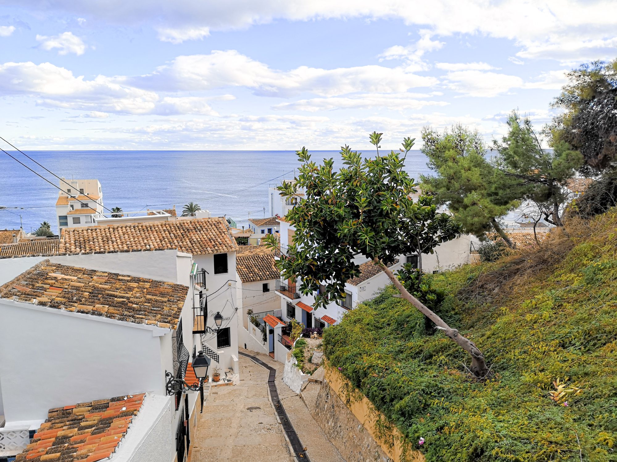 Whitewashed stepped lane in the old town of Altea leading down to the sea