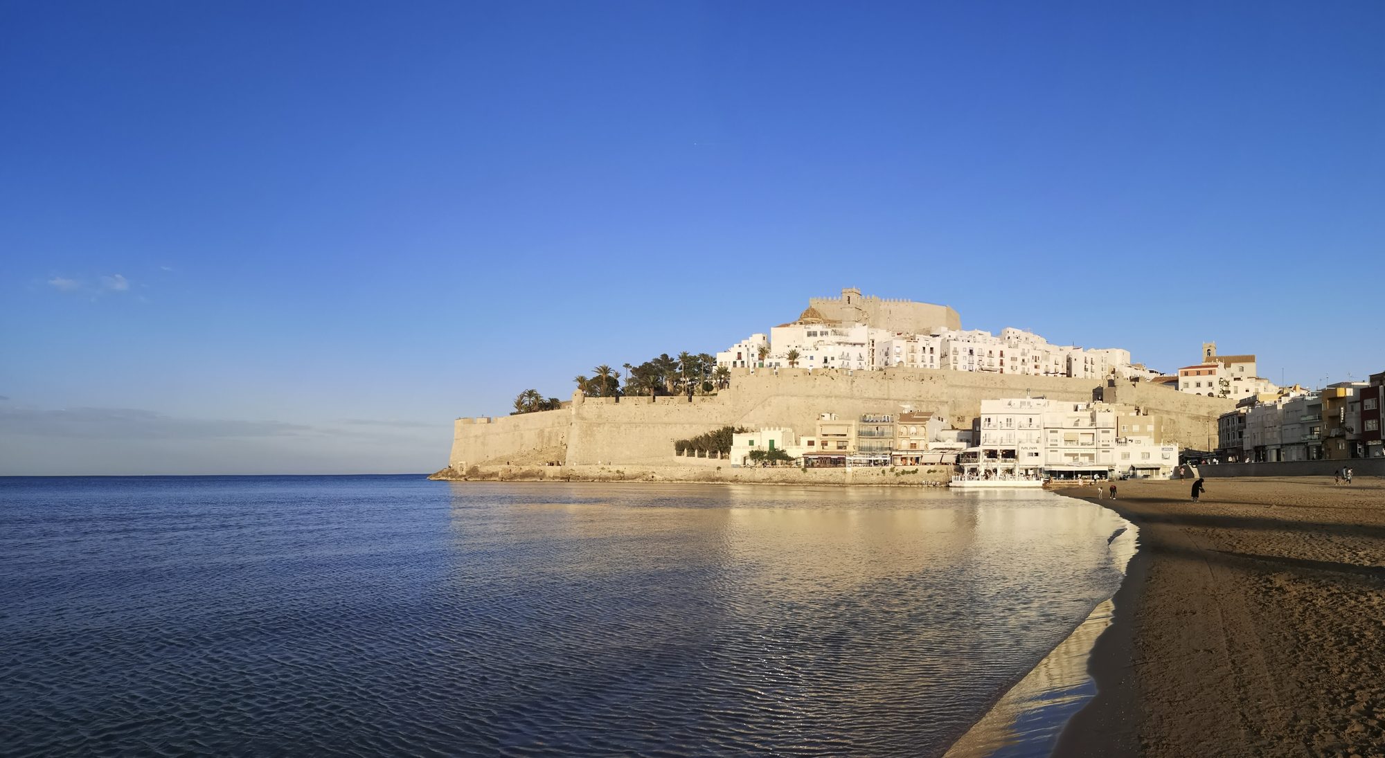 Peñíscola Castle (Castillo de Peñíscola) and old town on the promontory at golden hour