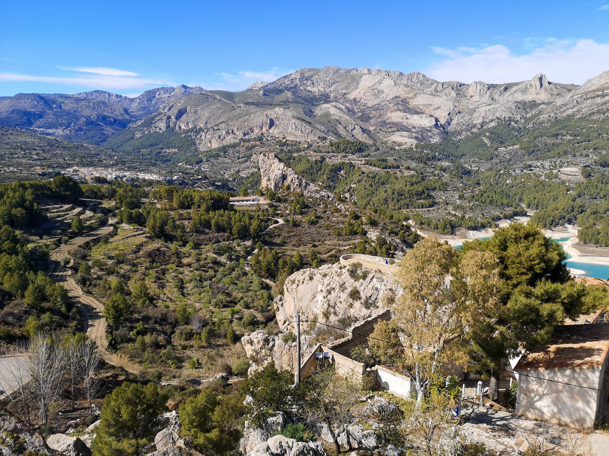 Terraces and mountains of the Guadalest valley with the edge of the Guadalest Reservoir (Embalse de Guadalest)