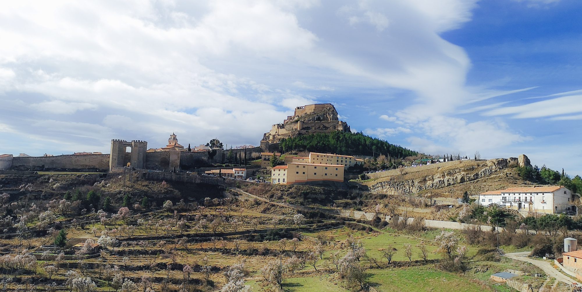 Walled town of Morella and Morella Castle (Castillo de Morella) above almond-blossom terraces
